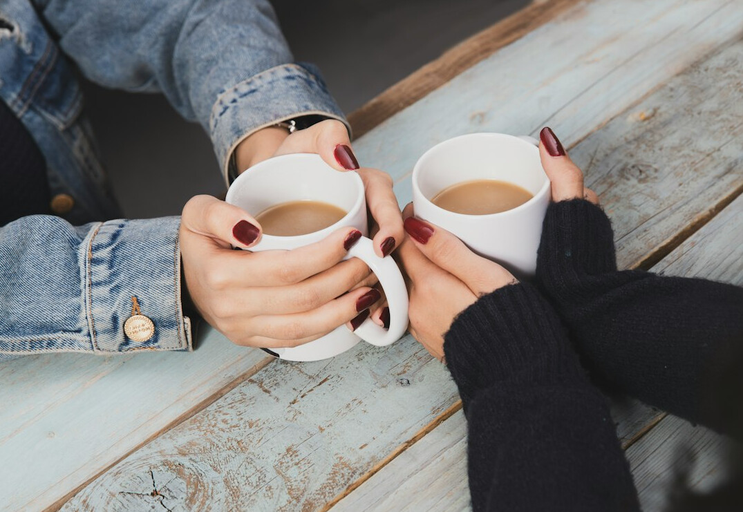 Two people having a warm conversation over coffee