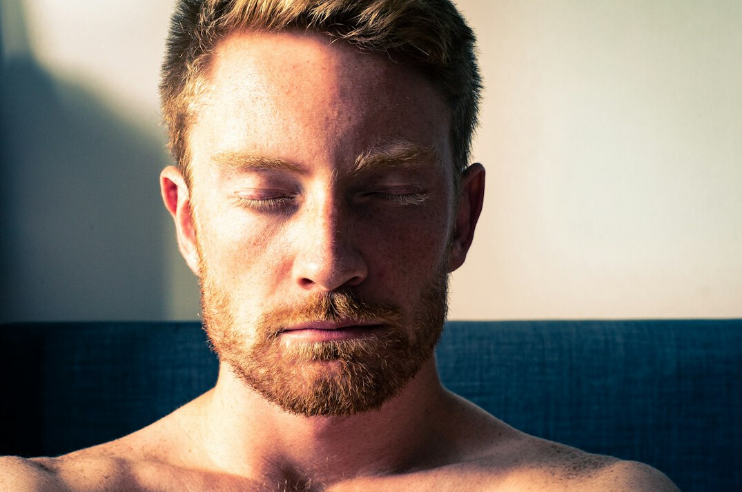 Person meditating calmly with eyes closed