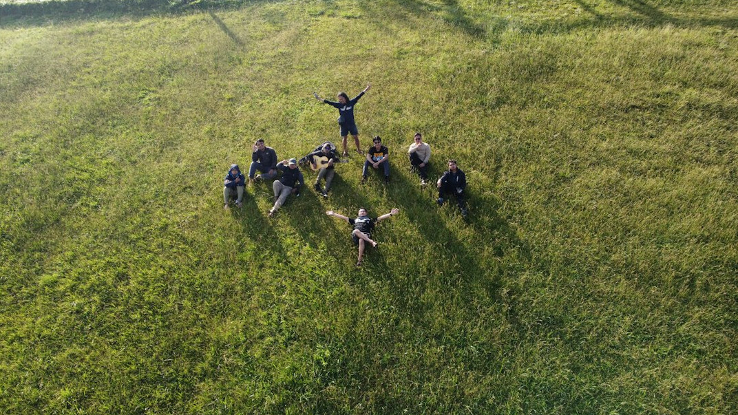 Diverse group of people seated in a circle discussing