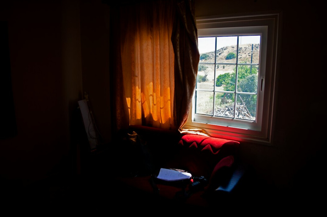 Person journaling by a window in soft light
